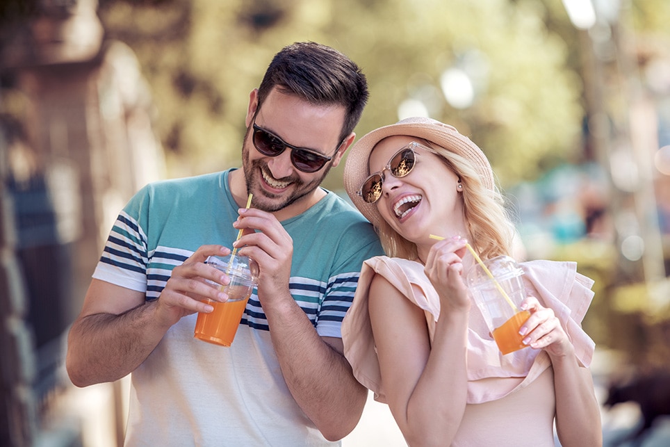 Couple smiling while drinking juice