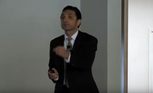 Dr Karen in a suit giving a presentation or lecture.