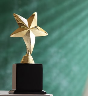 Star trophy with dark wood base and a dark green background