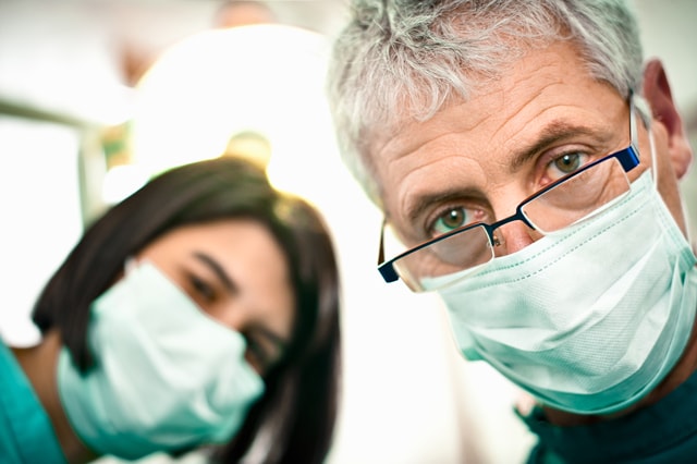 Two doctors with masks looking at the front