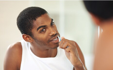 man brushing his teeth