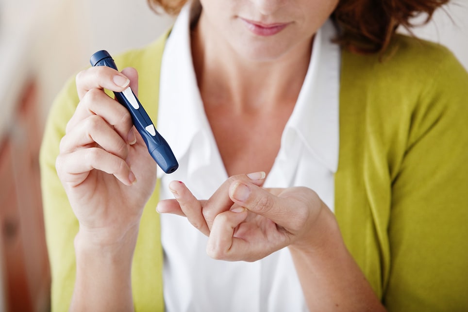 Woman using the glucometer